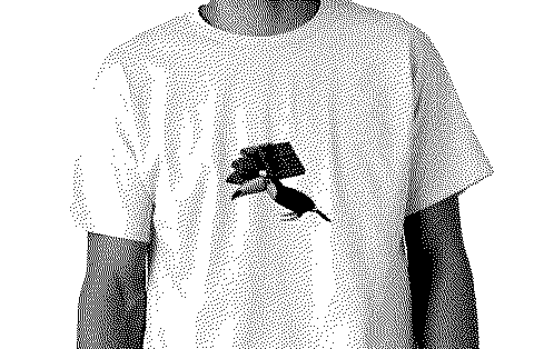 Dithered photograph of a white t-shirt printed with a toucan under a stack of chocolate.